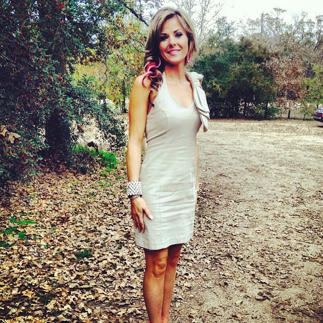 Lea Penick in a white bodycon dress with a white wrist jewelry.